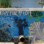 Murals turn a dam into art at Elmendorf Lake on the West Side of San Antonio.