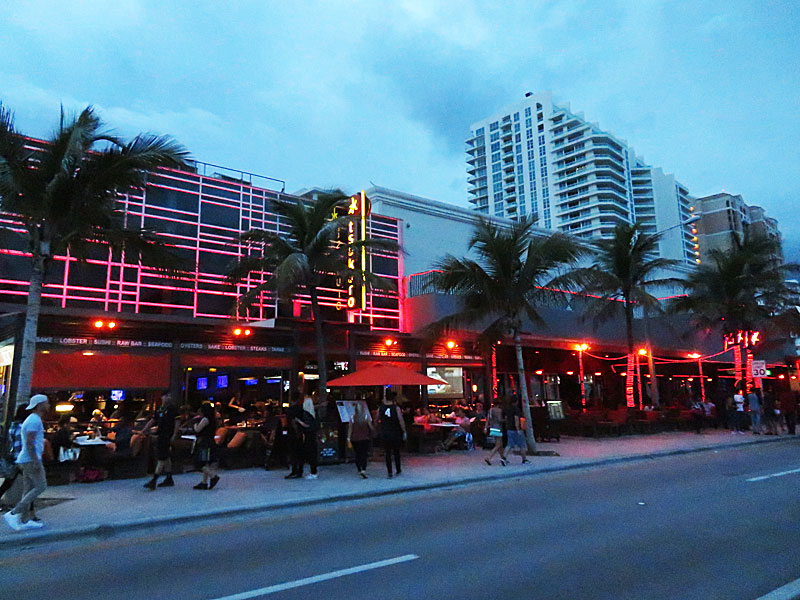 The lights of the restaurants and bars enliven the scene across the street from the beach in Fort Lauderdale, Florida. - photos by Joe Alexander