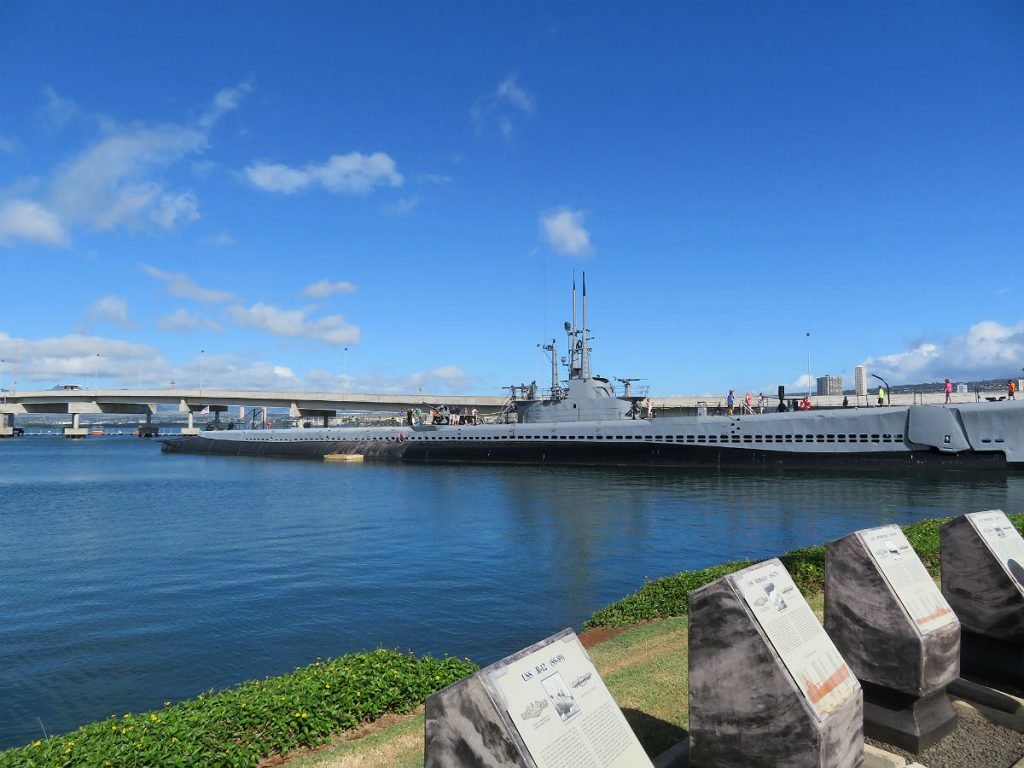 The Battleship Missouri and USS Arizona Memorial are at center stage at Pearl Harbor with the red-and-white World War II control tower in the background and the USS Bowfin submarine nearby. - photos by Joe Alexander