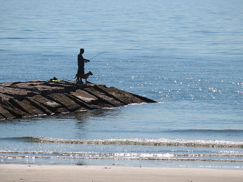 A fisherman takes advantage of a calm morning in Galveston, Texas. - photo by Joe Alexander